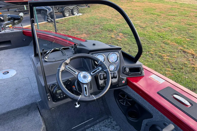 Slide: The Image of 2026 Tracker Targa V-19 Combo boat dashboard with steering wheel and gauges. - 6