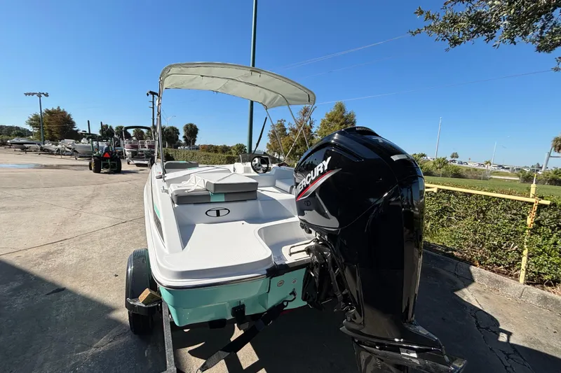 Slide: The Image of 2026 Tahoe T16 boat with Mercury engine on trailer, parked outdoors. - 3