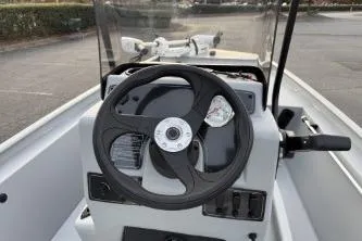 Slide: The Image of 2026 Tracker Bass Tracker Classic CC boat steering console with controls and windshield. - 56