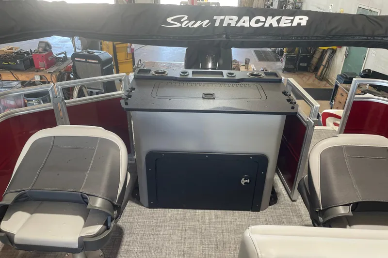 Slide: The Image of 2026 Sun Tracker SportFish 22 XP3 boat interior with seating and control panel. - 9