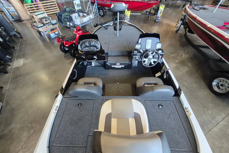 Slide: The Image of 2026 Nitro Z17 boat interior with steering wheel and seating, displayed in showroom. - 9