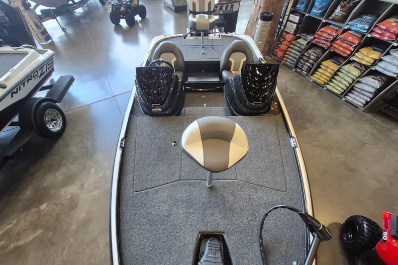 Slide: The Image of 2026 Nitro Z17 boat interior with seating and storage, displayed in a showroom. - 11