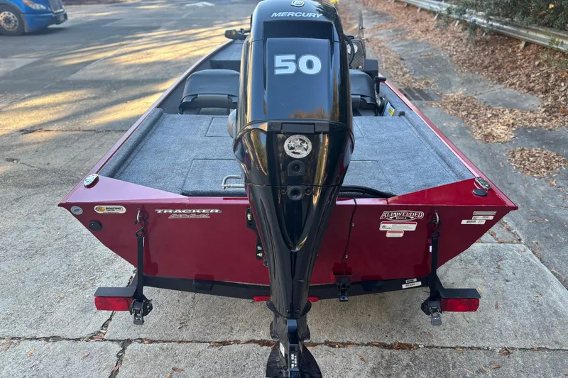 Slide: The Image of 2026 Tracker Bass Tracker Classic XL boat with Mercury 50 engine, parked on pavement. - 2