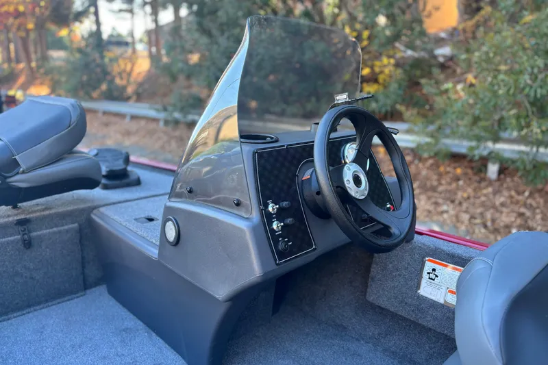 Slide: The Image of 2026 Tracker Bass Tracker Classic XL boat interior with steering wheel and dashboard. - 3