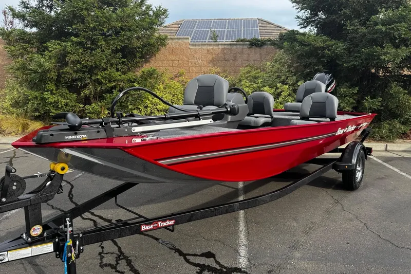 Slide: The Image of 2026 Tracker Bass Tracker Classic XL boat, red, parked outdoors on a trailer. - 2