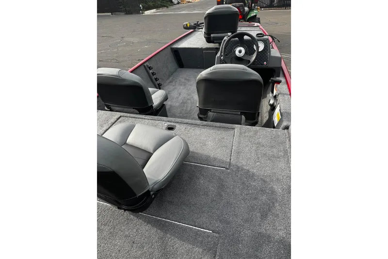 Slide: The Image of 2026 Tracker Bass Tracker Classic XL interior with gray seating and steering console. - 4