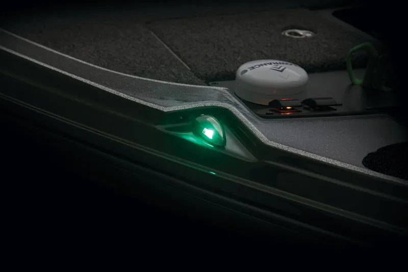 Slide: The Image of Storage compartment of 2026 Triton 20XP Patriot with Garmin electronics and documents. - 24