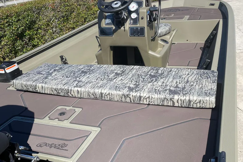 Slide: The Image of 2026 Tracker Grizzly 1860 CC boat interior with camouflage seating and steering console. - 3