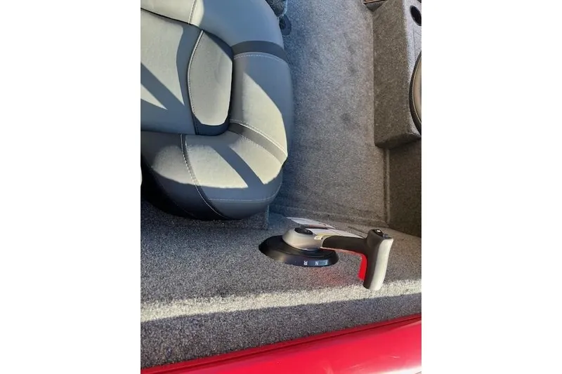 Slide: The Image of 2026 Tracker Pro Team 195 boat interior with gear shift lever and seat. - 5