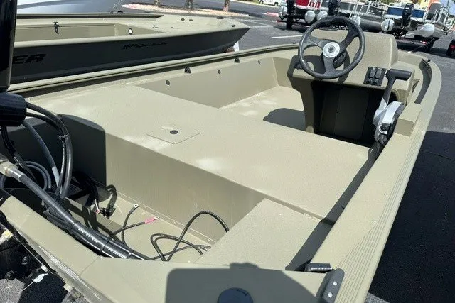 Slide: The Image of 2026 Tracker Grizzly 1648 SC boat interior with steering console, showcasing spacious layout and controls. - 9