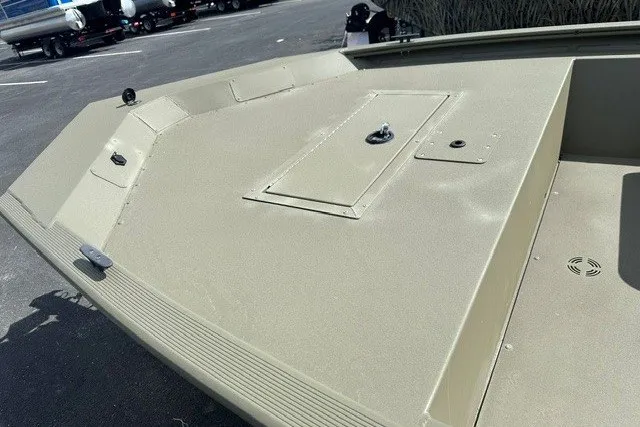 Slide: The Image of 2026 Tracker Grizzly 1648 SC boat deck, featuring a sleek, durable design in a parking area. - 6