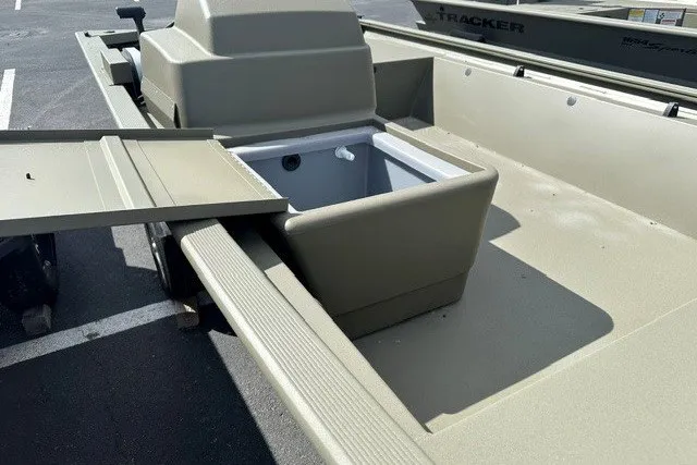 Slide: The Image of 2026 Tracker Grizzly 1648 SC boat interior with storage compartment and seating. - 11