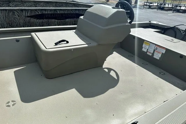 Slide: The Image of 2026 Tracker Grizzly 1648 SC boat interior with seating and storage compartments. - 7
