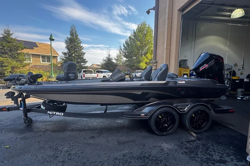 The Image of 2026 Nitro Z19 XL Pro boat on trailer, parked outside a garage. - 0