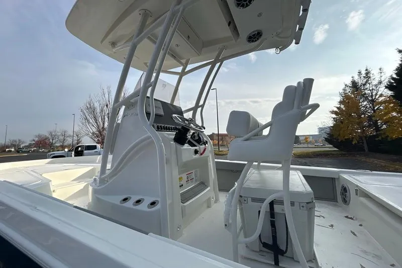 Slide: The Image of 2026 Mako 24 APEX boat interior with helm and seating, showcasing modern design. - 10