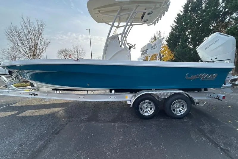 Slide: The Image of 2026 Mako 24 APEX boat on trailer, featuring sleek design and Mercury engine. - 6