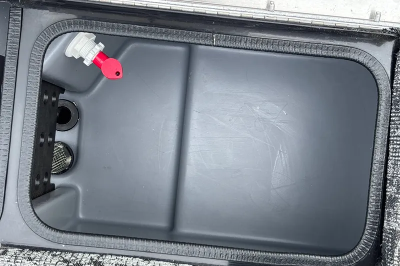 Slide: The Image of Livewell compartment of 2026 Tracker Pro Team 195 boat, featuring a red valve. - 26