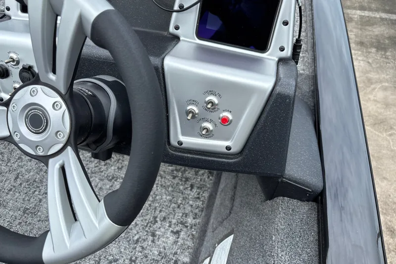 Slide: The Image of Steering wheel and control panel of 2026 Tracker Pro Team 195 boat. - 14