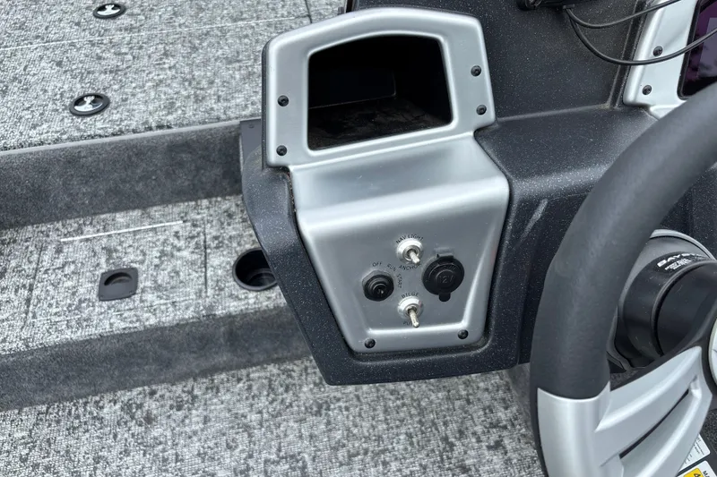 Slide: The Image of Control panel of 2026 Tracker Pro Team 195 boat with switches and steering wheel. - 25