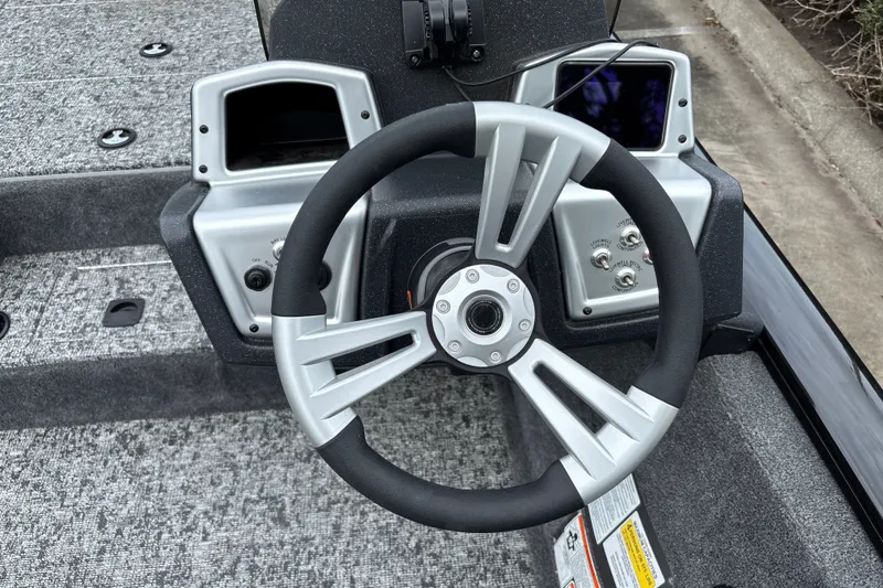 Slide: The Image of Steering wheel of 2026 Tracker Pro Team 195 boat, featuring modern controls and dashboard. - 13