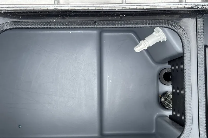 Slide: The Image of Livewell compartment of 2026 Tracker Pro Team 195 boat, featuring drainage and aeration system. - 27