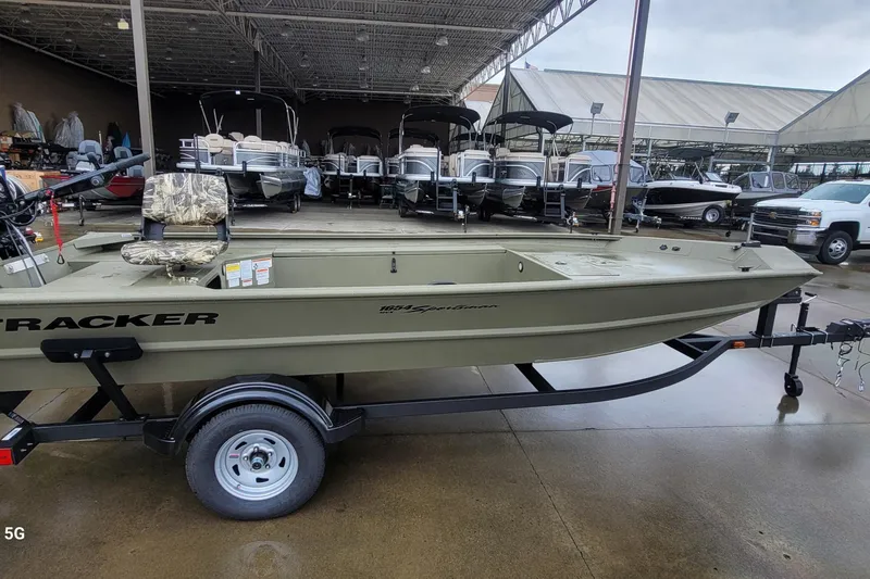 The Image of 2026 Tracker Grizzly 1654 T Sportsman boat on trailer in showroom. - 0