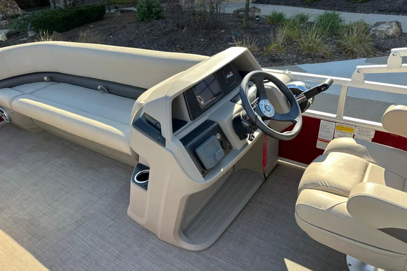 Slide: The Image of 2024 Sun Tracker Party Barge 18 DLX interior with steering console and seating. - 4