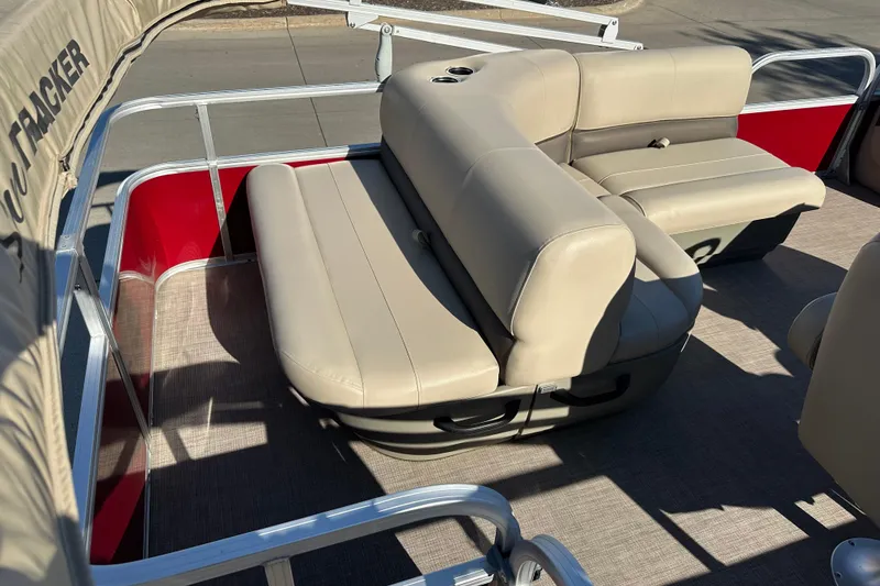 Slide: The Image of 2024 Sun Tracker Party Barge 18 DLX with beige seating and red accents. - 7