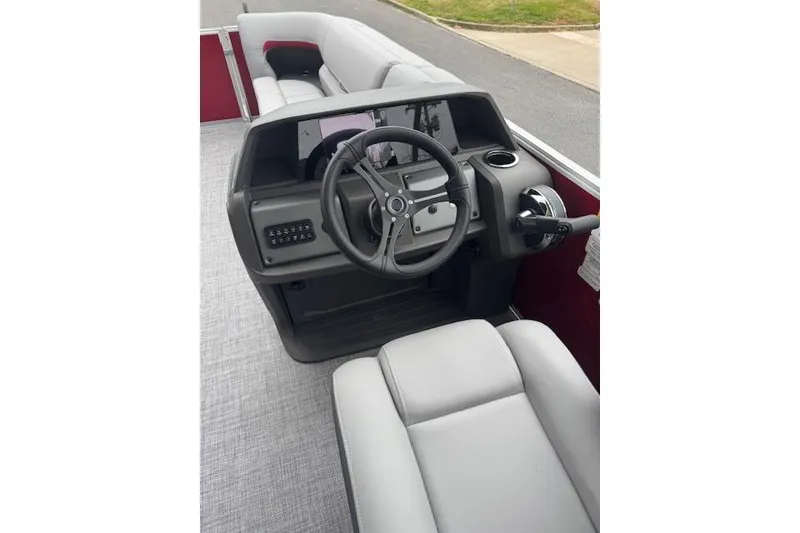Slide: The Image of 2026 Sun Tracker Party Barge 22 DLX interior with steering console and seating. - 12