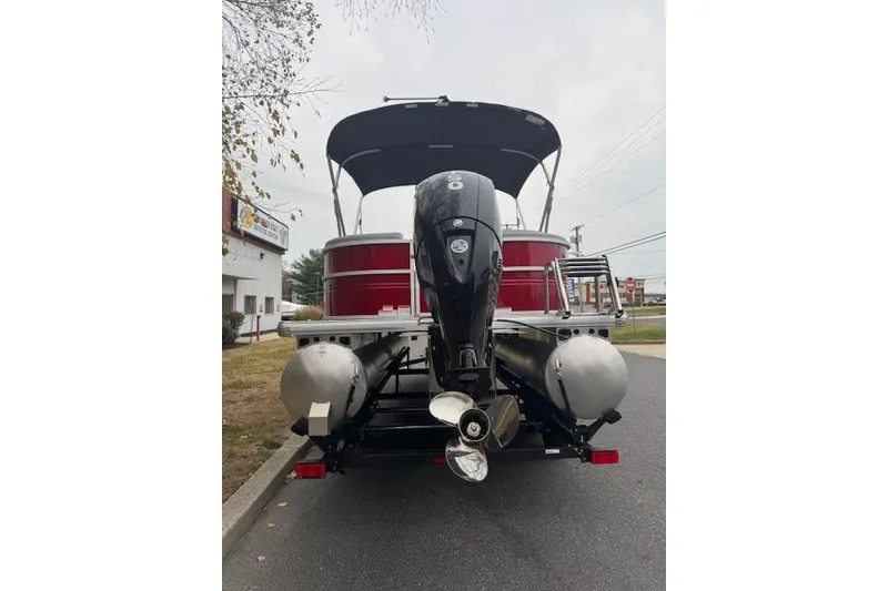Slide: The Image of 2026 Sun Tracker Party Barge 22 DLX pontoon boat with outboard motor, rear view. - 3