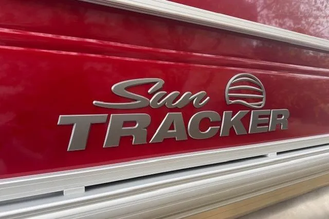 Slide: The Image of 2026 Sun Tracker Party Barge 22 DLX logo on red exterior. - 4