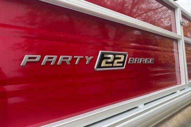 Slide: The Image of 2026 Sun Tracker Party Barge 22 DLX, red exterior with logo detail. - 5