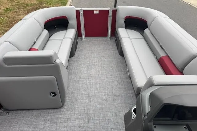 Slide: The Image of 2026 Sun Tracker Party Barge 22 DLX interior with gray and red seating. - 7
