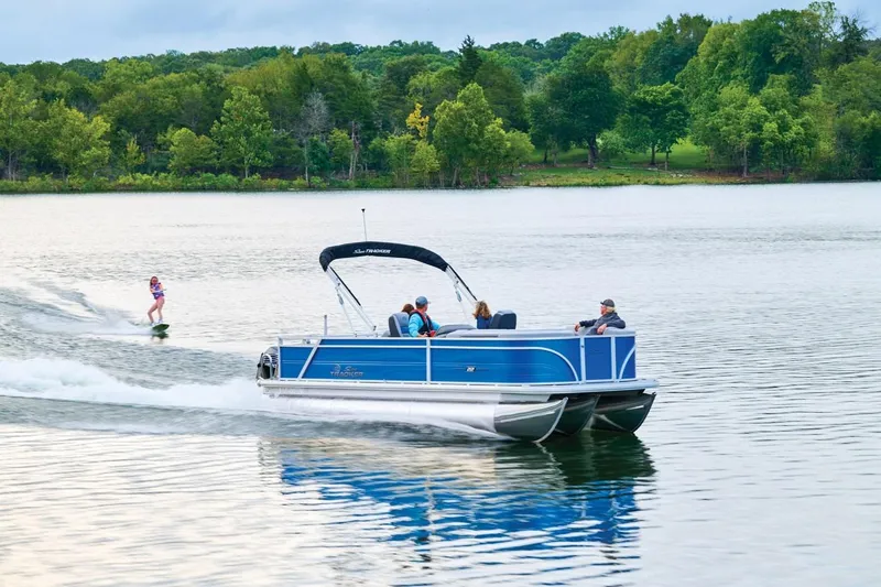 Slide: The Image of 2026 Sun Tracker Party Barge 22 RF XP3 on a lake, towing a wakeboarder. - 10