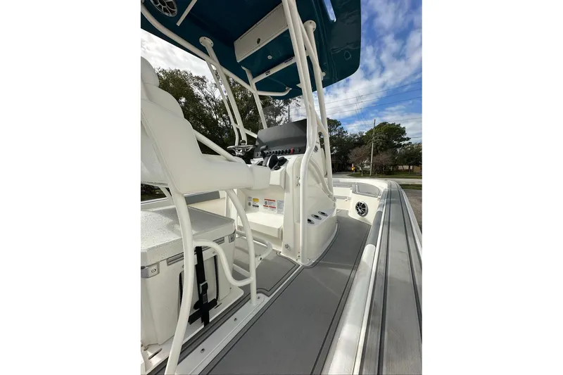 Slide: The Image of 2026 Mako 24 APEX boat interior with white seating and control panel. - 88