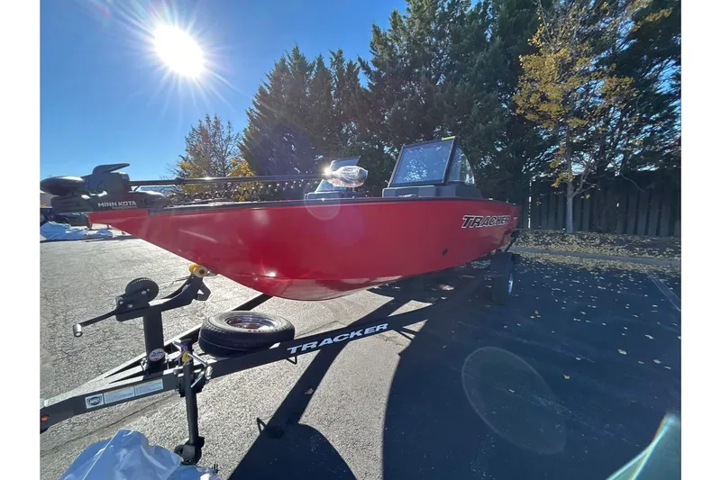 The Image of 2026 Tracker Pro Guide V-175 Combo boat in vibrant red on a trailer under sunny skies. - 0