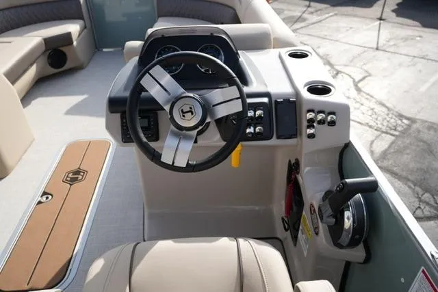 Slide: The Image of 2026 Harris Cruiser 230 boat interior with steering wheel and control panel. - 14