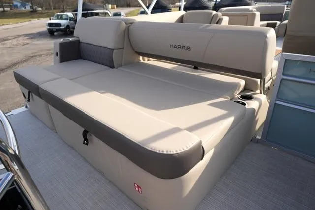 Slide: The Image of 2026 Harris Cruiser 230 boat with beige seating and cup holders. - 16