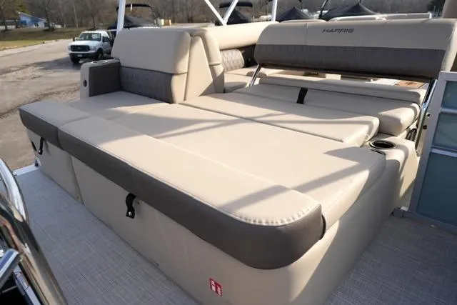 Slide: The Image of 2026 Harris Cruiser 230 boat with spacious beige seating and cup holders. - 17