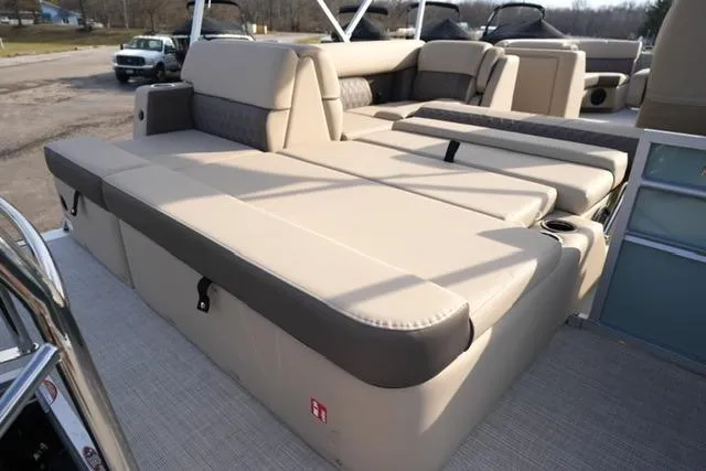 Slide: The Image of 2026 Harris Cruiser 230 boat with spacious beige seating and modern design. - 18