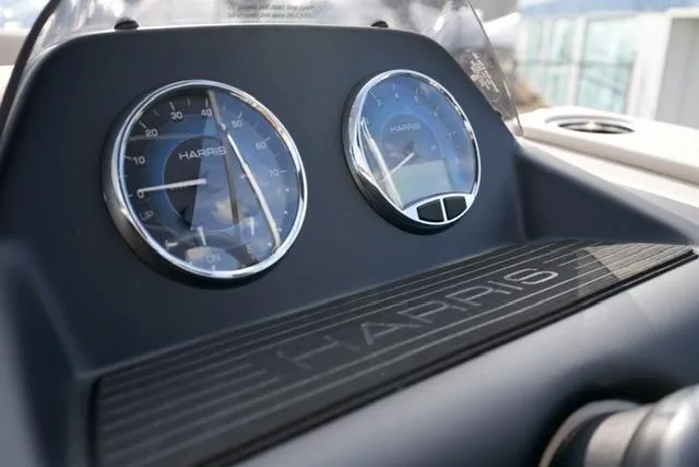 Slide: The Image of Dashboard of 2026 Harris Cruiser 230 boat with gauges and branding. - 19