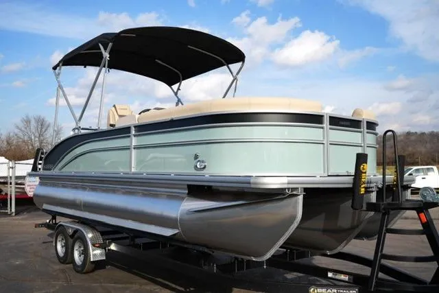 Slide: The Image of 2026 Harris Cruiser 230 pontoon boat on trailer, featuring sleek design and canopy. - 5