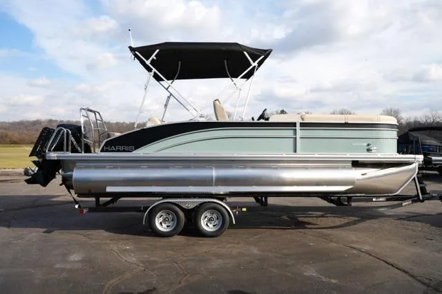 Slide: The Image of 2026 Harris Cruiser 230 pontoon boat on trailer, featuring sleek design and canopy. - 6