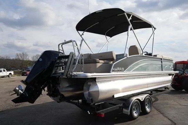 Slide: The Image of 2026 Harris Cruiser 230 pontoon boat on trailer, featuring sleek design and powerful outboard motor. - 7