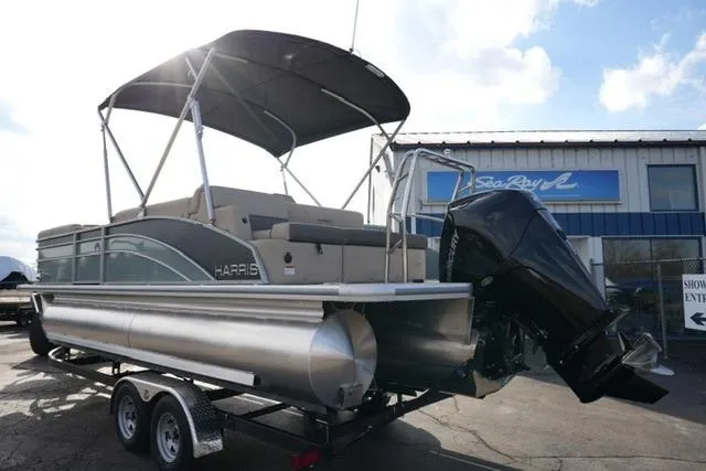 Slide: The Image of 2026 Harris Cruiser 230 pontoon boat on trailer, featuring a sleek design and powerful outboard motor. - 8