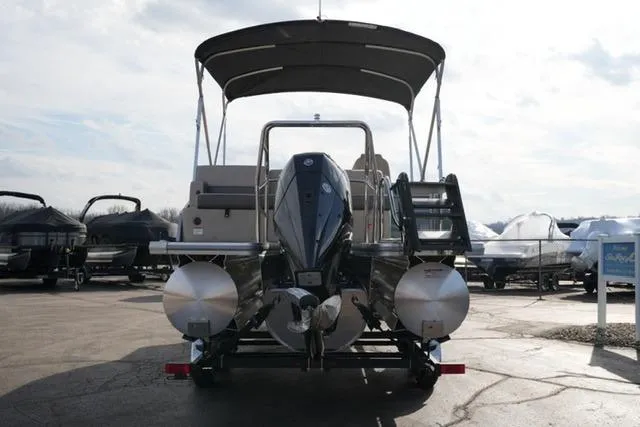 Slide: The Image of 2026 Harris Cruiser 230 pontoon boat with canopy, displayed outdoors. - 9