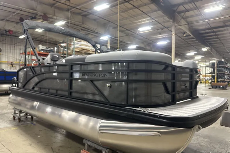 Slide: The Image of 2026 Bennington 20 S Cruise pontoon boat in a warehouse setting. - 8