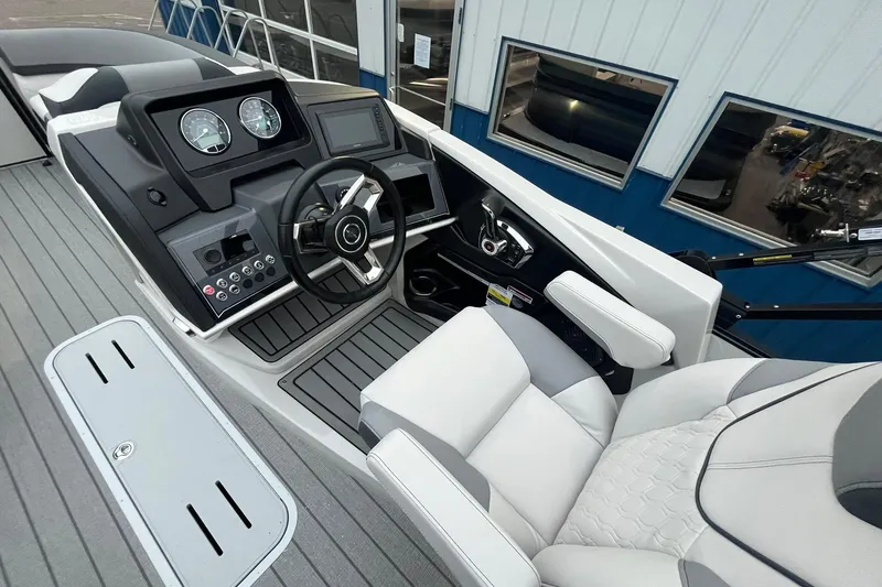 Slide: The Image of 2026 Avalon Catalina Versatile Rear Lounger boat interior with modern dashboard and steering. - 18