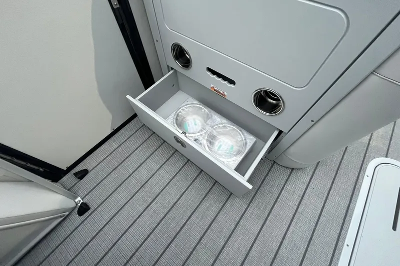 Slide: The Image of 2026 Avalon Catalina Versatile Rear Lounger with open storage drawer on deck. - 20