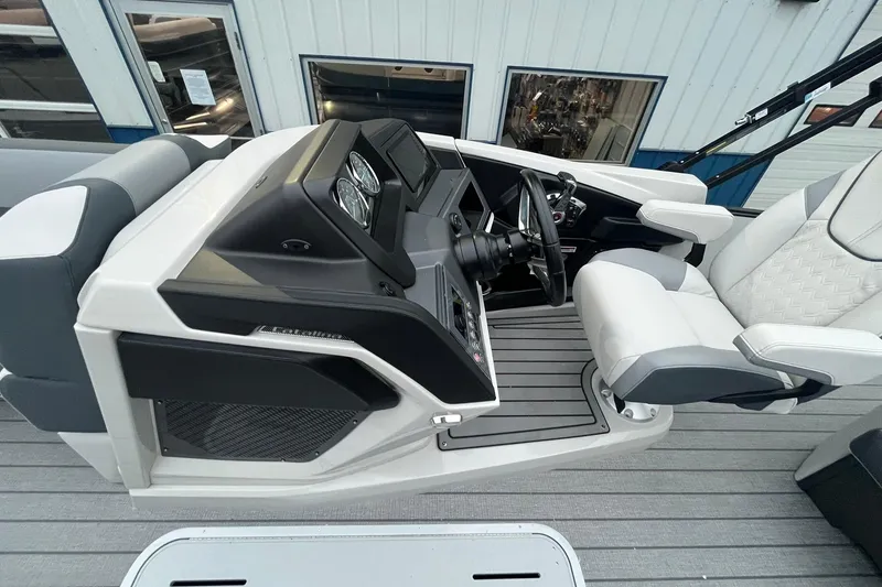 Slide: The Image of 2026 Avalon Catalina Versatile Rear Lounger boat interior with modern helm and seating. - 22